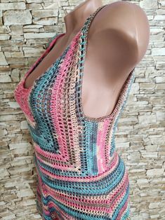 a mannequin is wearing a multicolored crocheted tankini top