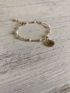 PLEASE INCLUDE BABIES WRIST MEASUREMENT AND  AGE AT CHECKOUT. OR I CAN MAKE AN AVERAGE FOR BABIES AGE REQUESTED IF ITS A GIFT.INCLUDE INTIAL OF LITTLE ONE This darling little 14k gold filled bracelet is custom made for your little one. I handmade this in all sizes baby and child.A sweet big sister gift or birthday gift for little one. I can make a mommy set as well. Can be made with sterling silver instead of 14k gold upon request. Include that in notes.  This is the perfect gift for baby naming Gold Charm Bracelet Baby, Baby Boy Jewelry Gold Bracelets, Adjustable Personalized White Gold Bracelet, Personalized Adjustable White Gold Bracelet, Dainty Personalized White Gold Bracelets, Dainty White Gold Name Bracelet, Adjustable 14k Gold Jewelry With Pearl Charm, Silver Stackable Pearl Bracelet Gift, 14k Gold-filled Silver Jewelry With Pearl Charm