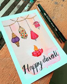 a happy diwal card on a table next to some pencils