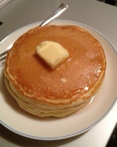 a stack of pancakes with butter on top