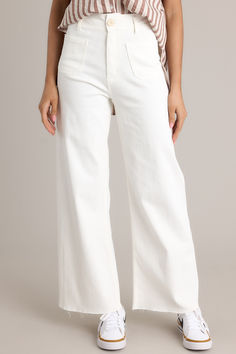 Model wearing white wide leg jeans.