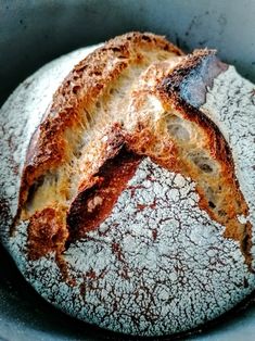 a loaf of bread sitting inside of a metal pan