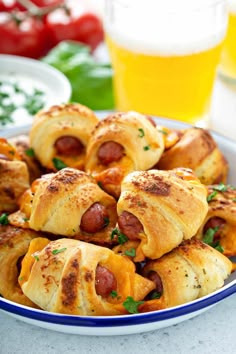 hot dogs wrapped in bread and garnished with parsley on a blue plate