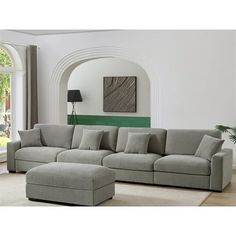 a living room with a sectional couch and ottoman