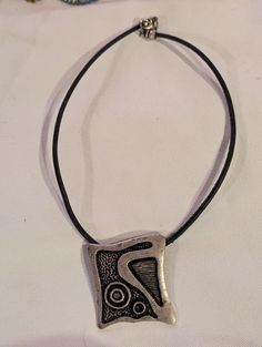 20" rubbery black cord with a lobster claw closure. The pendant is silver plated, my first picture shows the piece before I polished the pendant, the second shows it polished. So attractive and this really speaks to your love of abstract design. Looks great around the neck! Black Rubber, Lobster Claw, One Pic, Abstract Design, Boho Chic, Jewelry Necklace Pendant, Silver Plated, Silver Tone, Two By Two