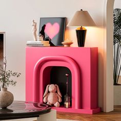 a pink fireplace with a stuffed animal on it