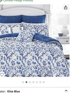 a blue and white comforter set in a bedroom