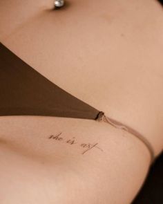 the back of a woman's stomach with writing on it