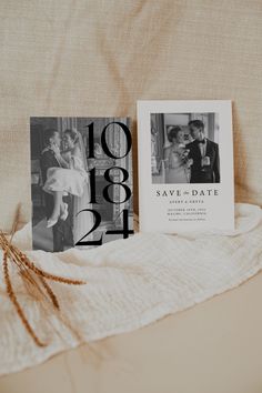 an image of a wedding save the date card and photo book on a bed sheet