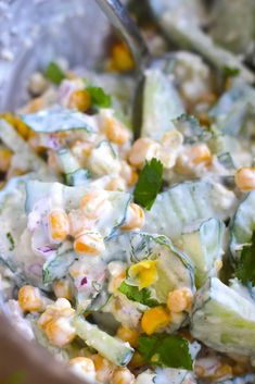 a salad with cucumbers, corn and cilantro