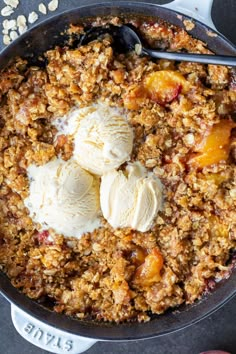 a skillet filled with fruit and ice cream