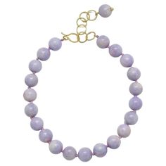 Striking strand of uniform Lavender Jade Beads, 19.5 - 20mm with an 18k gold* handmade clasp. The decorative oval link 2" extender, with its drop bead, allows for the necklace to be worn with the clasp in the front for a fun and stylish look. *In Faye Kim's signature 18k green gold, an alloy comprising 75% pure gold and 25% silver. Customizable in other precious metals and finishes. Length 18" + 2" extension Made in the USA Luxury Purple Jewelry With Round Beads, Elegant Lavender Beaded Bracelets, Elegant Single Strand Amethyst Beaded Necklace, Elegant Purple Necklace With Large Beads, Elegant Lavender Jewelry With Round Beads, Elegant Lavender Necklaces With Gemstone Beads, Elegant Lavender Round Bead Jewelry, Elegant Lavender Beaded Necklace With Natural Stones, Elegant Lavender Round Beaded Jewelry