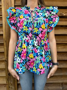 Add a pop of playful color to your wardrobe with our Field Of Flowers Blue Mix Floral Blouse! Featuring a vibrant floral pattern with pops of pink, yellow, blue, green, and white, and a stylish blue trim on the ruffled sleeves. Complete the look with the keyhole tie in the front. Perfect for adding a touch of brightness to any outfit! Sizes Available: Regular and Curvy Sizes (S-2X) Color: Blue Mix Model is 5'6", 125 lbs, and is wearing a small! True to Size. Material: 100% Polyester Sizes Availa 125 Lbs, Mixed Models, Field Of Flowers, Flowers Blue, Bootie Sandals, Blue Trim, Ruffled Sleeves, Toddler Tees, Flower Field