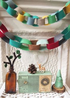 an old radio and some decorations on a mantle