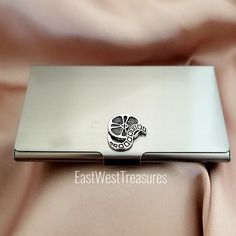 a silver laptop computer sitting on top of a pink cloth covered tablecloth with a shamrock emblem