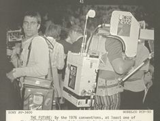 two men standing next to each other in front of an advertisement for the future television show