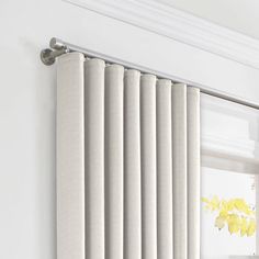 a white radiator hanging on the side of a wall next to a window