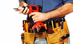 a man holding a tool belt with many tools in his pockets and one hand on the clipboard