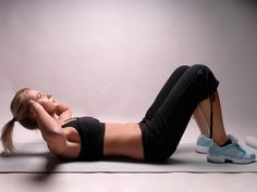 a woman laying on the ground with her legs crossed