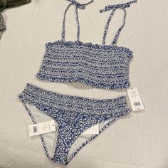 Floral Tory Burch Bikini. Never Worn. Smocked Top. Blue And White Size L. Tags Attached. Priced To Sell No Trades Please! Beach Season Smocked Top, Vacation Smocked Ruched Stretch Top, Vacation Smocked Stretch Top With Ruched Details, Beach Season Vacation Smocked Top, Beach Season Smocked Top For Vacation, Stretch Ruched Smocked Top For Vacation, Fitted Smocked Top For Beach, Smocked Bodice Top For Beach Season Vacation, Beach Season Smocked Bodice Top