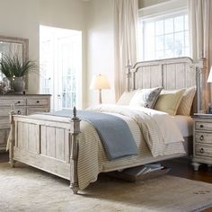 a bedroom scene with focus on the bed and dresser