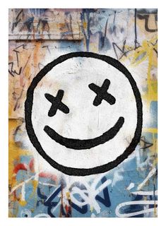 a smiley face painted on the side of a wall with graffiti all over it's surface