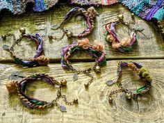 several bracelets are arranged on a wooden surface