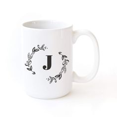 a white coffee mug with the letter j on it