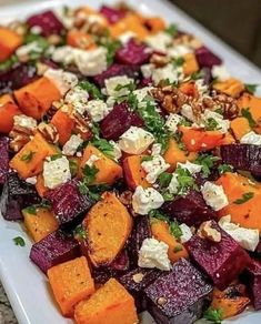 a white plate topped with beets and feta cheese