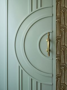 a close up of a door with a gold handle on it's knobs