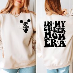 In My Cheer Mom Era Sweatshirt, Custom Cheer Mama Sweatshirt, Cheer Mom Gift, Your Kids Name,Football Mom Sweatshirt, Funny Cheerleading Mom   PRODUCT DETAILS - Our sweatshirts are made for comfort with a 50% cotton and 50% polyester blend. - They're built to last with a medium-heavy fabric (8.0 oz/yd²). - Enjoy a relaxed fit and a sewn-in label. - Get the right size with our true-to-size guide.   SIZING - Find your perfect fit in our size chart with pictures. - For oversize look, you might cons White Cheerleading Fan Apparel Sweatshirt, Pre-shrunk Long Sleeve Sweatshirt For Cheerleading, Pre-shrunk Long Sleeve Cheerleading Sweatshirt, White Team Spirit Sweatshirt For Cheerleading, Long Sleeve T-shirt With Team Name For Cheerleading, Varsity Long Sleeve Sweatshirt For Cheerleading, Long Sleeve Tops For Cheerleading With Team Spirit, Long Sleeve Tops For Cheerleading Team Spirit, Long Sleeve T-shirt With Lettering For Sports Events