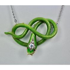 This is part of Chairish’s Fine Jewelry assortment.  Victorian Green Enamel Snake Pendant 18K  This gorgeous Victorian Enamel Snake Pendant is unusual in color and the fact that this is not a brooch but a pendant makes it more so. There are 2 hooks to place a chain that are slightly hidden. You can always add a pin to make this a brooch but I just love it on a chain. I photographed this piece with a Platinum chain, but a yellow gold chain will work just as nicely. This piece weights in at 20.9 g Enamel Brooch Pendant Jewelry, Green Sterling Silver Brooch Jewelry, Green Sterling Silver Brooch, Sterling Silver Green Brooch, Handmade Enamel Jewelry For Formal Occasions, Luxury Handmade Enamel Jewelry, Unique Green Snake-shaped Jewelry, Luxury Snake-shaped Jewelry Gift, Luxury Snake-shaped Jewelry For Gifts