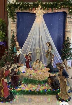 a nativity scene with figurines and lights