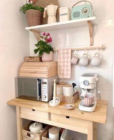 a small kitchen area with coffee maker, toaster and other items on the counter