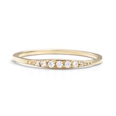 a yellow gold ring with five diamonds