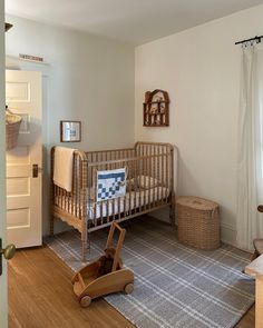 a baby's room with a crib, rocking horse and other items on the floor