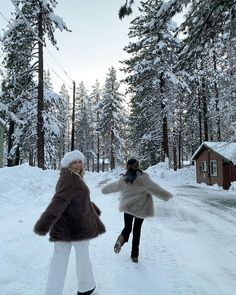 two women walking down a snow covered road