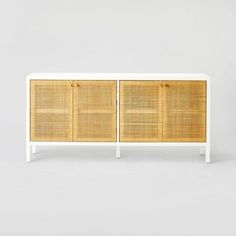 the sideboard is made out of rattan and white wood