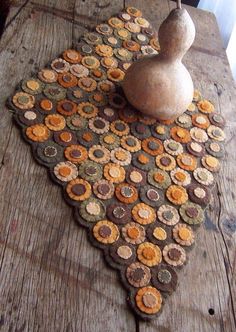 an old wooden table with a vase on top of it and some corks in the middle