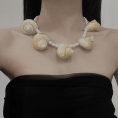 Features: Material: natural freshwater pearls, natural conch Color: The color of the conch is light gold, and the inside of the conch is gold. Size: Conch size is approximately 4-5 cm Note: Pearls and conch are both natural materials. Their surfaces are not smooth and may have traces of growth. Please do not buy if you mind. Natural Elegance: This handmade light gold seashell necklace adorned with natural freshwater pearls exudes captivating natural beauty. Each seashell is meticulously selected Summer Pearl Shell Necklace, White Shell-shaped Pearl Necklace, Pearl White Shell Necklace, White Pearl Shell Necklace, Cream Shell-shaped Shell Jewelry, Pearl White Shell Necklace For Beach, Ocean-inspired Pearl Shell, Pearl White Shell For Beach, Handmade Pearl Shell-shaped Shell