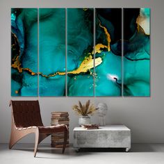 an abstract painting on a wall in a living room with a chair and coffee table