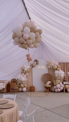 balloons and chairs are set up in the middle of a room with white drapes