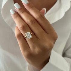 a woman's hand wearing a diamond ring