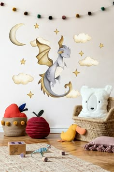 a child's room decorated in white and gold with a dragon wall decal