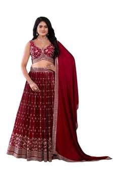 Crimson splendor unfurls as the deep red lehenga set commands attention, its intricate embroidery shimmering like rubies. The heavily embroidered blouse adds a touch of regal elegance, while the tonal dupatta flows like a velvet whisper. This stunning ensemble wraps the little one in a majestic aura of grace and poise, perfect for a tiny queen's grand celebration, exuding confidence and charm. Pre stitched lehenga for women. Crafted from a Georgette fabric for luxurious feel and touch. The blouse features sequin embroidery throughout. The sleeveless blouse features back opening with hook closure and tie ups Dry clean or hand wash for longer life. Note: Colors may slightly vary due to photographic lighting. Please contact us if you have any questions via email, social me Lehenga For Women, Regal Elegance, Red Lehenga, Embroidered Lehenga, Sequin Embroidery, Intricate Embroidery, Georgette Fabric, Sequins Embroidery, Clothing Sets