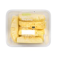 pineapple slices in a plastic container on a white background with the words frozen pineapple