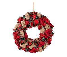 a red and green wreath hanging from a rope