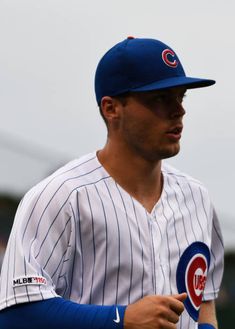 a chicago cubs baseball player wearing a blue and white uniform