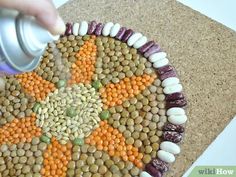 someone is decorating a plate with food on the floor and sprinkles