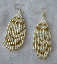 These fringe style earrings are handmade by me, Janet J. Griffen...  They are made with #11 glass seed beads...  The colors are white and gold glass seed beads and beaded with Nymo thread... Measurements of the earrings are 3 3/4 inches long by 1 inch wide and the ear hooks are of gold tone... Any questions, please e-mail me.... Artisan White Earrings With Beaded Fringe, Traditional White Beaded Fringe Jewelry, White Beaded Fringe Festival Jewelry, Festival White Beaded Fringe Jewelry, White Beaded Fringe Jewelry For Crafting, White Southwestern Beaded Earrings For Festivals, Southwestern Style White Beaded Dangle Earrings, Southwestern White Beaded Earrings For Festival, White Southwestern Style Beaded Earrings For Festival